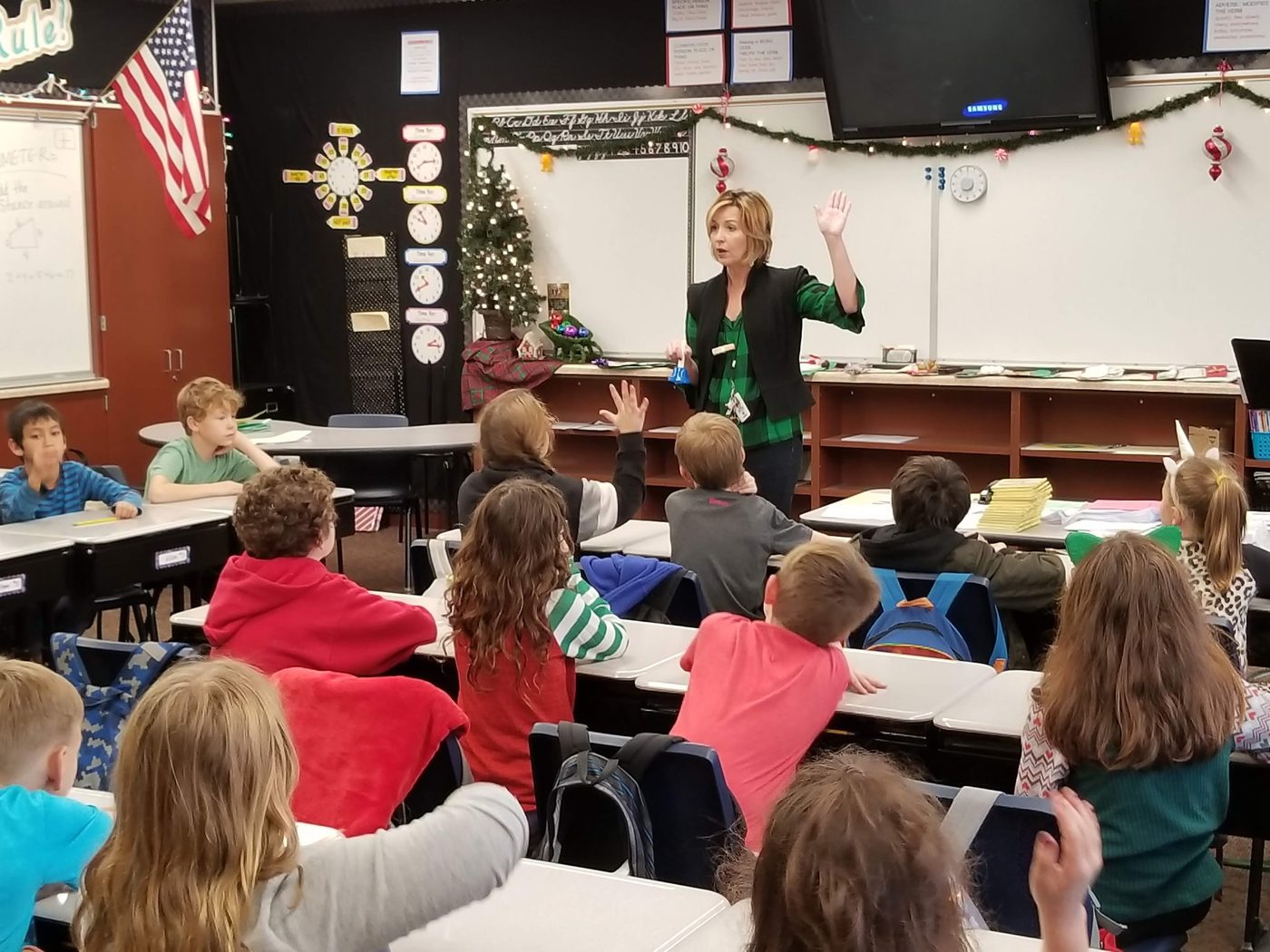 Teacher leading a classroom holiday activity