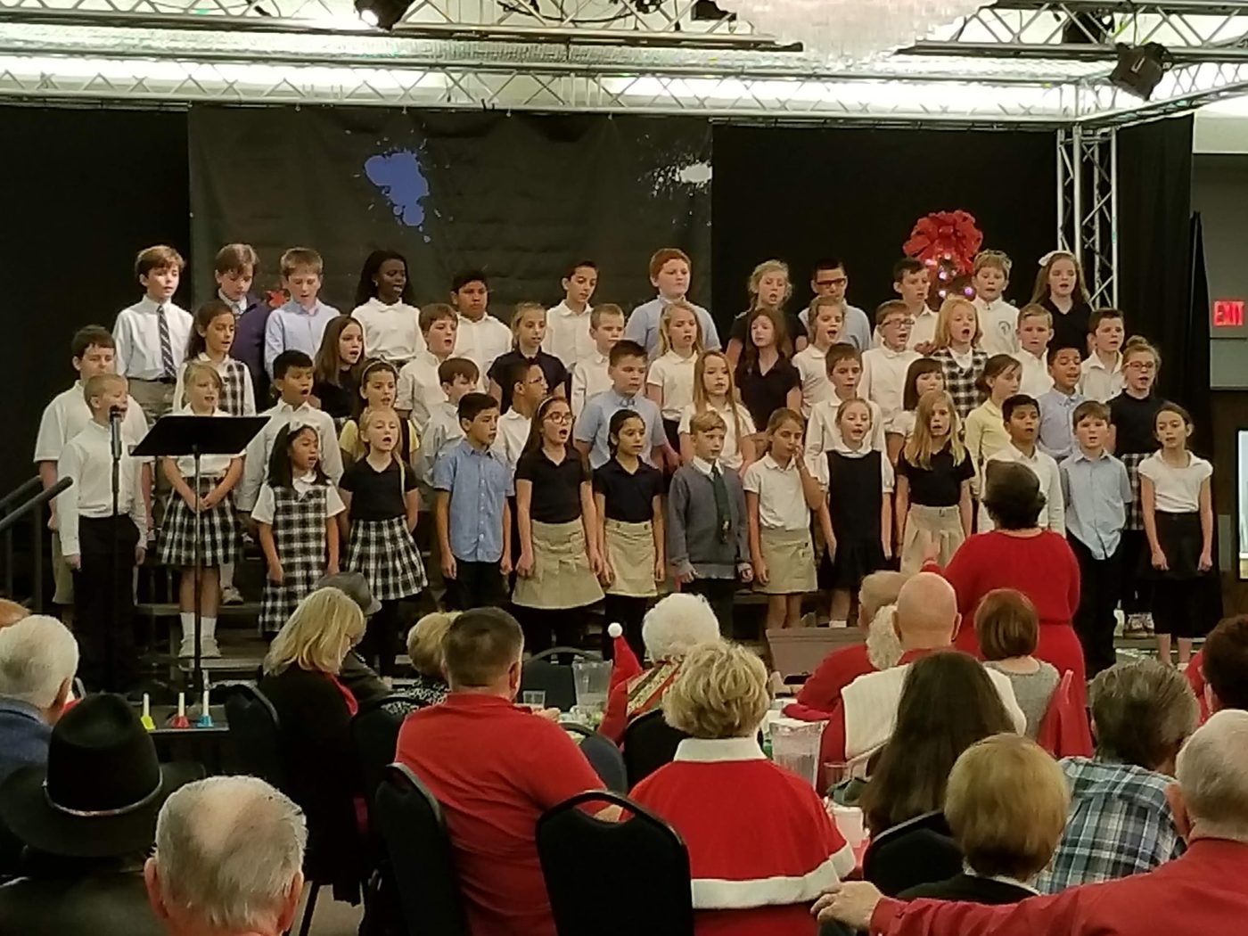Students performing under stage lights