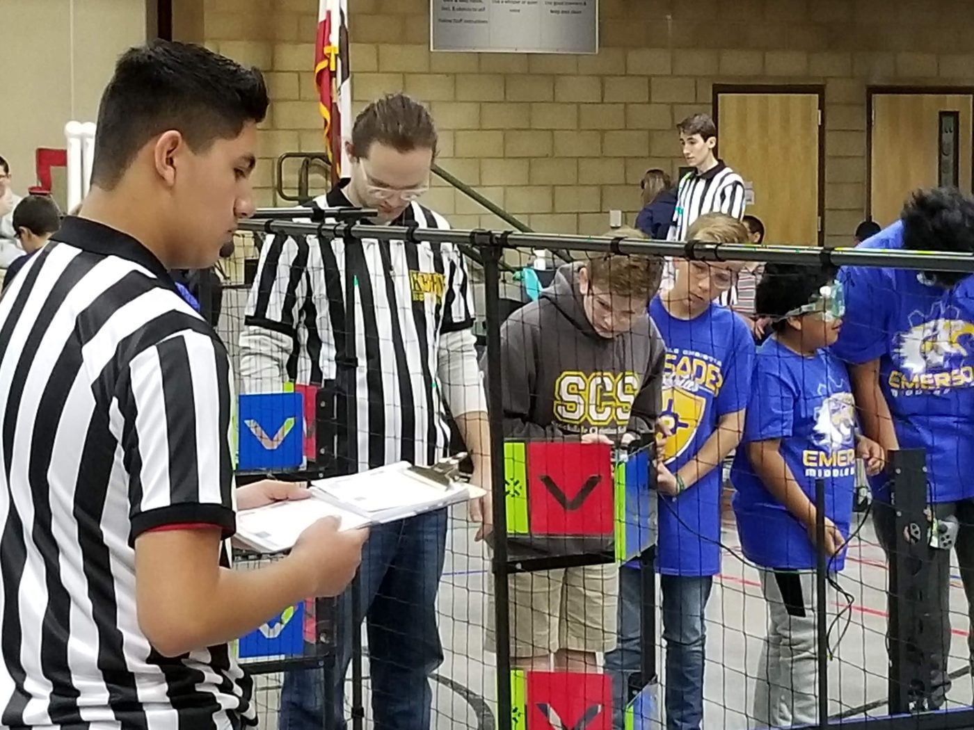 Referees officiating a robotics competition